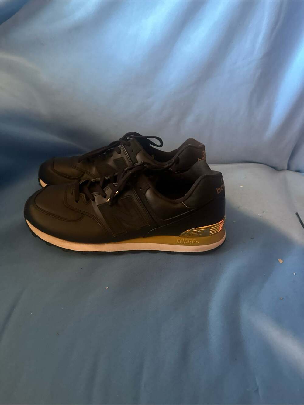 New Balance 574 Black and Gold Metallic Sneakers